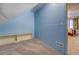 Attic space with blue walls, carpeting, and built-in shelving at 802 Sugar Creek Se Dr, Conyers, GA 30094