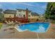 Spacious backyard with a large in-ground pool, lounge chairs, and a wooden deck for entertaining at 802 Sugar Creek Se Dr, Conyers, GA 30094