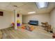Spacious finished basement with wood-look flooring and a comfortable seating area at 802 Sugar Creek Se Dr, Conyers, GA 30094