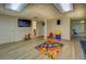 Finished basement area with vinyl floors, television, and access to other rooms at 802 Sugar Creek Se Dr, Conyers, GA 30094