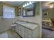 Bathroom featuring a vanity and a decorative mirror, with the bedroom visible through a doorway at 802 Sugar Creek Se Dr, Conyers, GA 30094