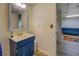 Basement half-bath with a blue vanity and a view into the main basement area at 802 Sugar Creek Se Dr, Conyers, GA 30094