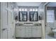 Bathroom with double sink vanity, granite countertop, and framed mirrors at 802 Sugar Creek Se Dr, Conyers, GA 30094