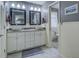 Bathroom with double sink vanity, granite countertop, and framed mirrors at 802 Sugar Creek Se Dr, Conyers, GA 30094