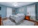 This charming bedroom features a ceiling fan, wood floors, and large windows at 802 Sugar Creek Se Dr, Conyers, GA 30094