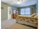 Spacious bedroom features a decorative quilt, carpeted floors, and lots of natural light at 802 Sugar Creek Se Dr, Conyers, GA 30094
