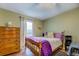Cozy bedroom with wood floors, dresser, window, and a star themed ceiling at 802 Sugar Creek Se Dr, Conyers, GA 30094