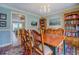 Formal dining room with a wooden table, chairs, and a view into the kitchen area at 802 Sugar Creek Se Dr, Conyers, GA 30094