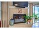Living room fireplace with brick surround, large windows, and cozy ambiance at 802 Sugar Creek Se Dr, Conyers, GA 30094
