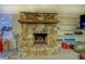 Basement fireplace with stone surround and built in shelving on either side at 802 Sugar Creek Se Dr, Conyers, GA 30094