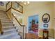 Elegant foyer with a staircase, chandelier, and an entry into the dining room at 802 Sugar Creek Se Dr, Conyers, GA 30094
