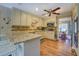 Bright kitchen with stainless steel appliances, granite countertops, and wood flooring at 802 Sugar Creek Se Dr, Conyers, GA 30094
