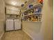 Bright laundry room with white washer and dryer with lots of pantry storage at 802 Sugar Creek Se Dr, Conyers, GA 30094