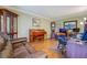 Cozy living room featuring hardwood floors, a leather sofa, and a wooden piano at 802 Sugar Creek Se Dr, Conyers, GA 30094