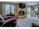 Comfortable living room with a fireplace, large windows, and seamless flow to the dining area at 802 Sugar Creek Se Dr, Conyers, GA 30094
