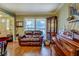 Inviting living room with hardwood floors, a comfortable leather sofa, and bright windows at 802 Sugar Creek Se Dr, Conyers, GA 30094