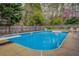 Large backyard pool with diving board, surrounded by mature trees, perfect for summer relaxation and entertainment at 802 Sugar Creek Se Dr, Conyers, GA 30094