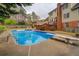 Backyard pool with diving board, set against a backdrop of lush greenery and mature trees, providing a private retreat at 802 Sugar Creek Se Dr, Conyers, GA 30094