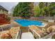 Backyard pool with lounge seating and a privacy fence is great for relaxing at 802 Sugar Creek Se Dr, Conyers, GA 30094