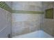 Shower featuring a tiled wall with a decorative accent at 802 Sugar Creek Se Dr, Conyers, GA 30094