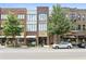 Charming building exterior with brick facade and modern windows, landscaped with mature trees and street parking at 1430 Dresden Dr # 225, Atlanta, GA 30319