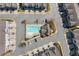 Overhead view of a community pool, clubhouse, and parking area, highlighting the layout and amenities at 2120 Sonoma Se Dr, Smyrna, GA 30080