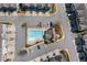 Overhead view of a community pool, clubhouse, and parking area, highlighting the layout and amenities at 2120 Sonoma Se Dr, Smyrna, GA 30080
