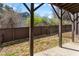 A peaceful, fenced backyard featuring a covered patio and a well-maintained grassy area and fence for privacy at 2120 Sonoma Se Dr, Smyrna, GA 30080