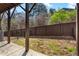 A fully fenced backyard featuring a covered patio and a well-maintained grassy area for outdoor activities at 2120 Sonoma Se Dr, Smyrna, GA 30080