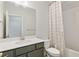 Bathroom with a white vanity, stylish mirror, and shower with decorative curtain at 2120 Sonoma Se Dr, Smyrna, GA 30080
