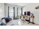 Bright bedroom features large windows with blue curtains, carpet and a modern desk with a monitor at 2120 Sonoma Se Dr, Smyrna, GA 30080