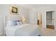 Light-filled bedroom features a plush bed, soft pillows, and artwork, creating a serene space at 2120 Sonoma Se Dr, Smyrna, GA 30080