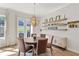 Dining room boasts hardwood floors, a modern chandelier, and a decorative sideboard at 2120 Sonoma Se Dr, Smyrna, GA 30080