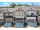 A modern townhome exterior features brick and siding, with a two-car garage and well-maintained landscaping at 2120 Sonoma Se Dr, Smyrna, GA 30080