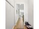 Hallway featuring hardwood floors, a shoe rack, and coat hooks, leading to the home's other living spaces at 2120 Sonoma Se Dr, Smyrna, GA 30080