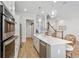 Kitchen boasts stainless steel appliances, a large island with seating, and hardwood floors at 2120 Sonoma Se Dr, Smyrna, GA 30080