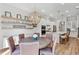 Kitchen and dining area with hardwood floors, modern lighting, stainless appliances, and white cabinets at 2120 Sonoma Se Dr, Smyrna, GA 30080
