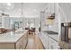 Modern white kitchen featuring a large island, stainless steel appliances, and an open-concept design at 2120 Sonoma Se Dr, Smyrna, GA 30080