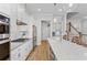 This kitchen features white cabinets, stainless steel appliances, hardwood floors, and a large kitchen island at 2120 Sonoma Se Dr, Smyrna, GA 30080