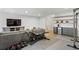 Bright living room features a large couch, exercise equipment, and shelving with a beverage cooler at 2120 Sonoma Se Dr, Smyrna, GA 30080