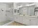 Well-lit bathroom featuring double vanity, modern finishes, and a glass-enclosed tiled shower at 2120 Sonoma Se Dr, Smyrna, GA 30080