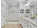 Well-lit bathroom featuring double vanity, modern finishes, and a glass-enclosed tiled shower at 2120 Sonoma Se Dr, Smyrna, GA 30080