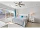 Bright main bedroom featuring large window, modern ceiling fan, and comfortable king bed at 2120 Sonoma Se Dr, Smyrna, GA 30080