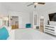 Bright main bedroom featuring modern ceiling fan, comfortable king bed, and adjacent sitting area at 2120 Sonoma Se Dr, Smyrna, GA 30080