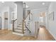 Beautiful staircase with white risers and wood treads, complemented by modern decor and lighting at 2120 Sonoma Se Dr, Smyrna, GA 30080