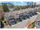 Attractive street view of a townhome community with mixed brick and siding exteriors, attached garages, and landscaped lawns at 2120 Sonoma Se Dr, Smyrna, GA 30080