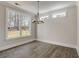 Well-lit dining room features modern chandelier, large windows, and hardwood floors at 3298 Rangers Gate, Marietta, GA 30062