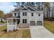 Beautiful two-story home featuring a welcoming front porch and a two-car garage at 3298 Rangers Gate, Marietta, GA 30062