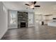 Spacious living area showcasing a stone fireplace and a modern kitchen with a kitchen island at 3298 Rangers Gate, Marietta, GA 30062