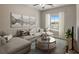 Comfortable living room with decorative art, plush sectional sofa, window and a modern ceiling fan at 3298 Rangers Gate, Marietta, GA 30062
